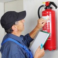 a fire extinguisher being examined